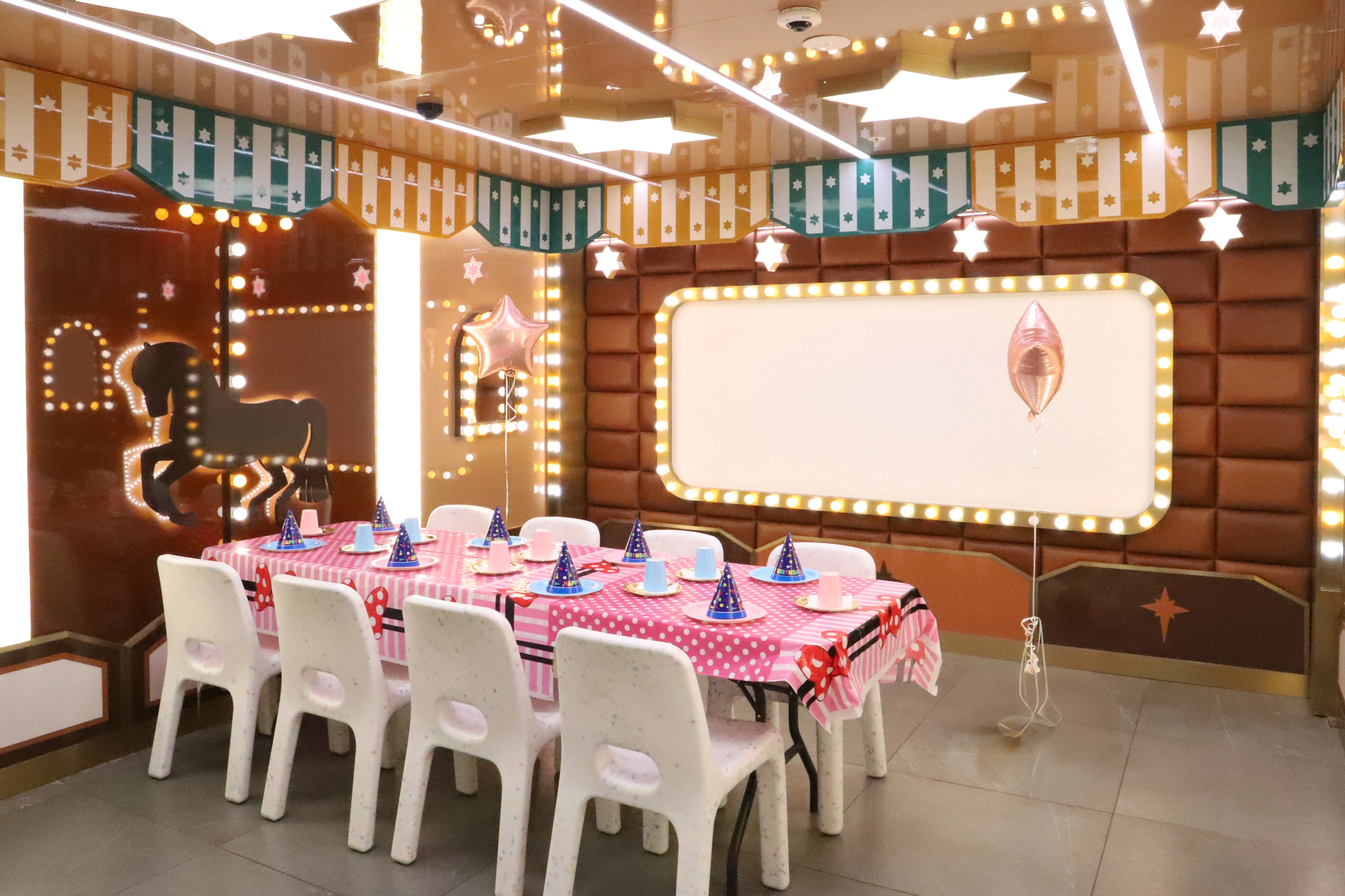 Private birthday party room set up with a decorated table and party hats at KOKO Amusement Town Hall