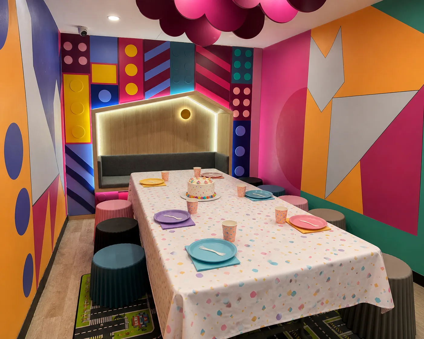Private party room at KOKO Amusement with bench seating, party table and colourful ceiling decoration