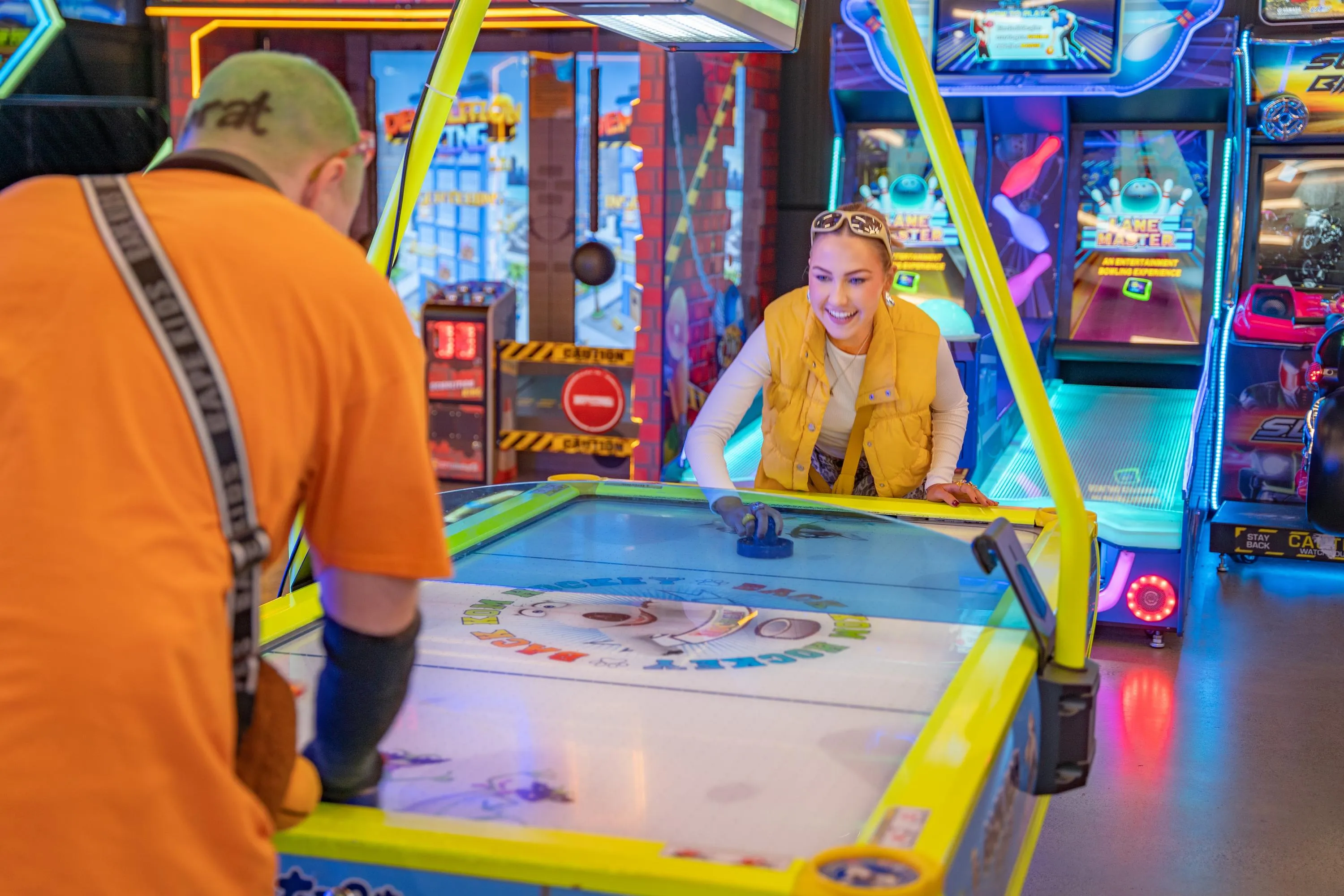 Two colleagues playing air hockey together at KOKO Amusement in Sydney CBD