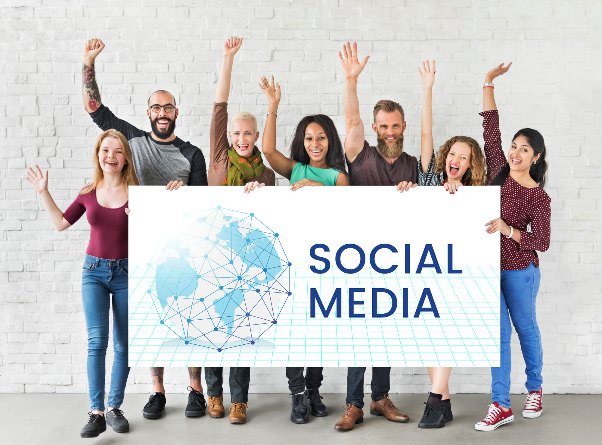 social media marketers happily holding a banner that says social media 