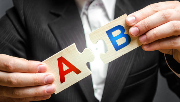 businessman connects puzzles with the letters A and B