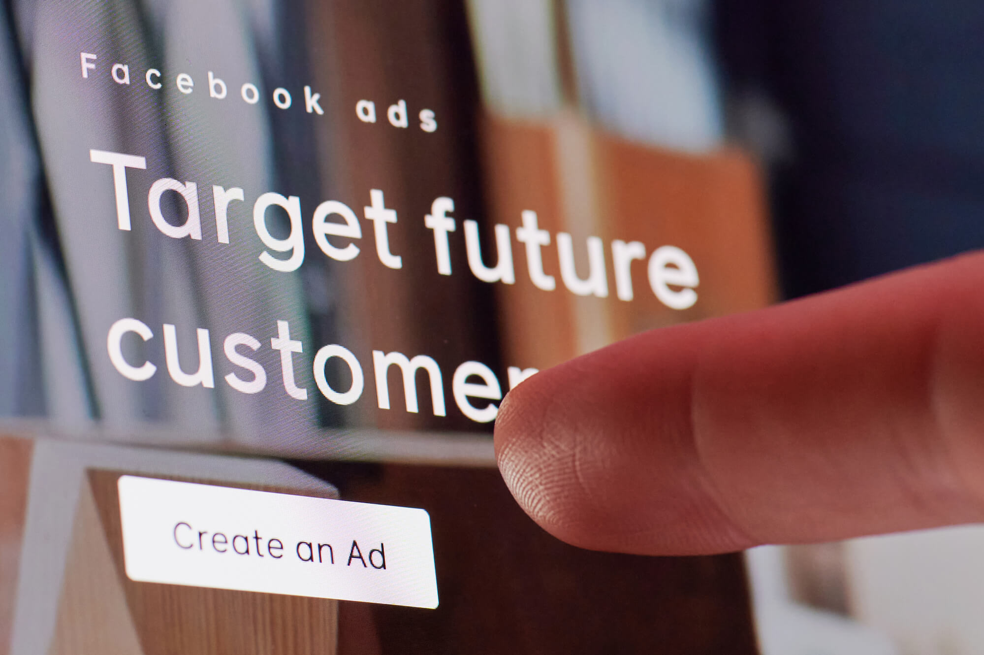 finger pointing at facebook ads' create an ad button