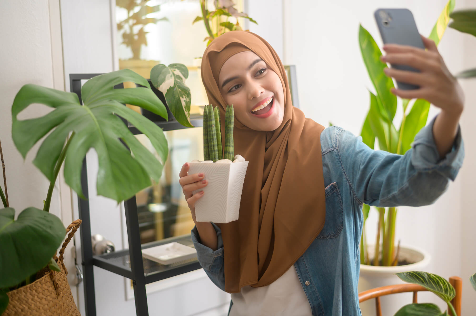 woman recording a video of herself reviewing a plant