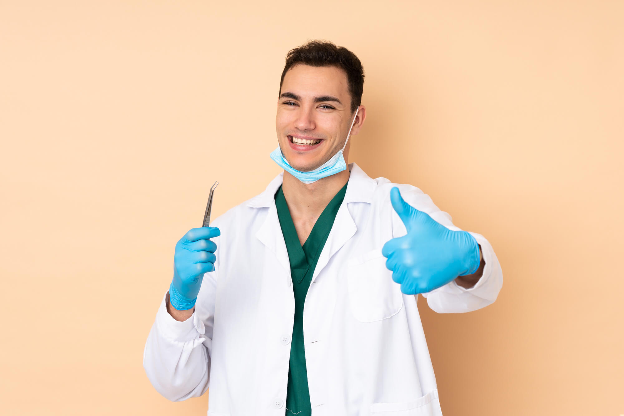 happy male dentist throwing a thumbs up