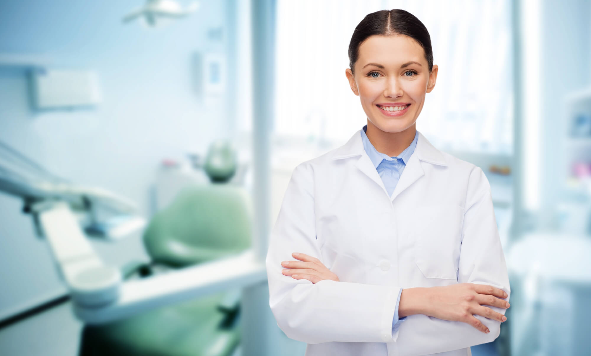 female dentist smiling and crossing arms