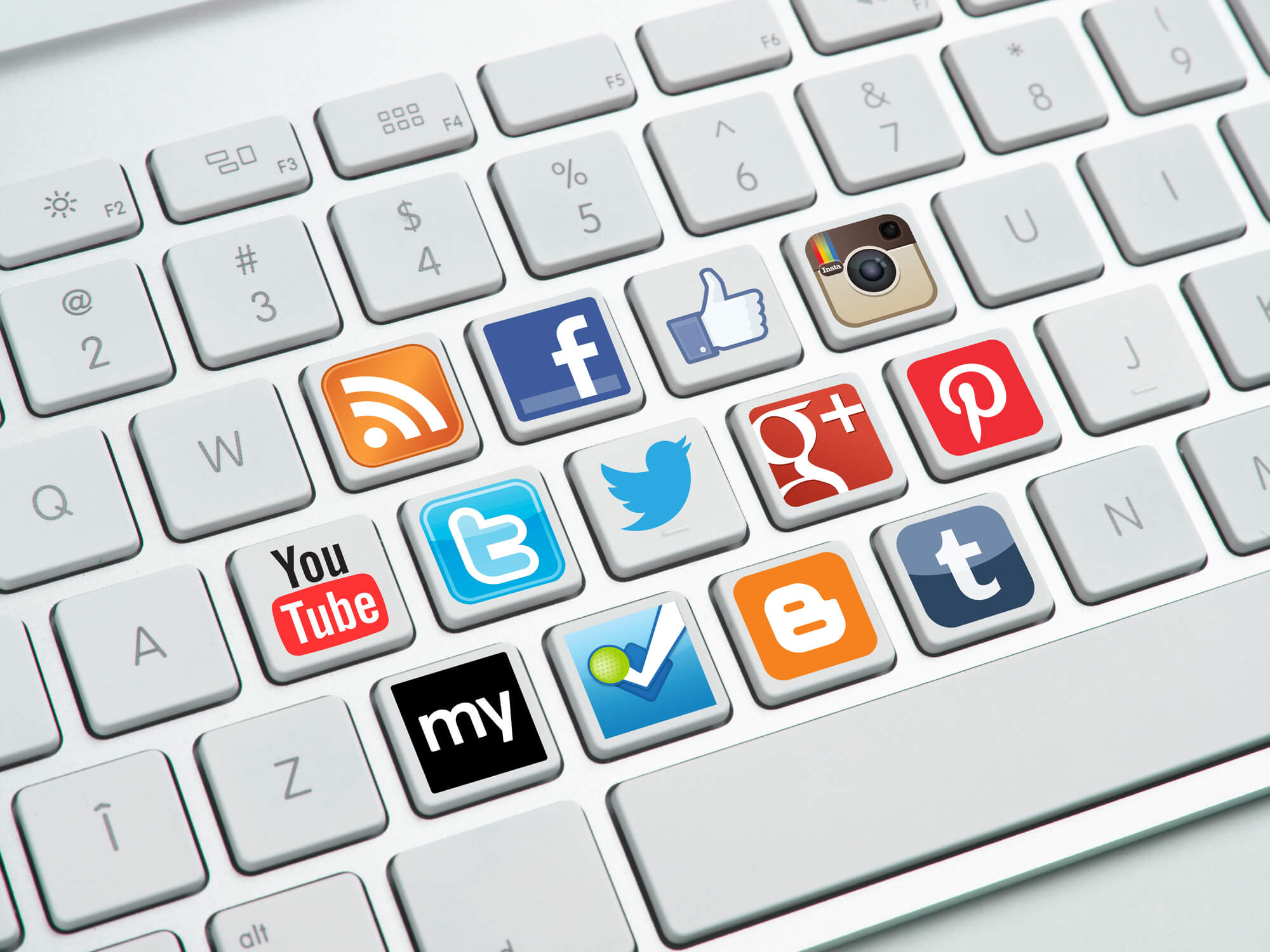 different social media logos on keyboard