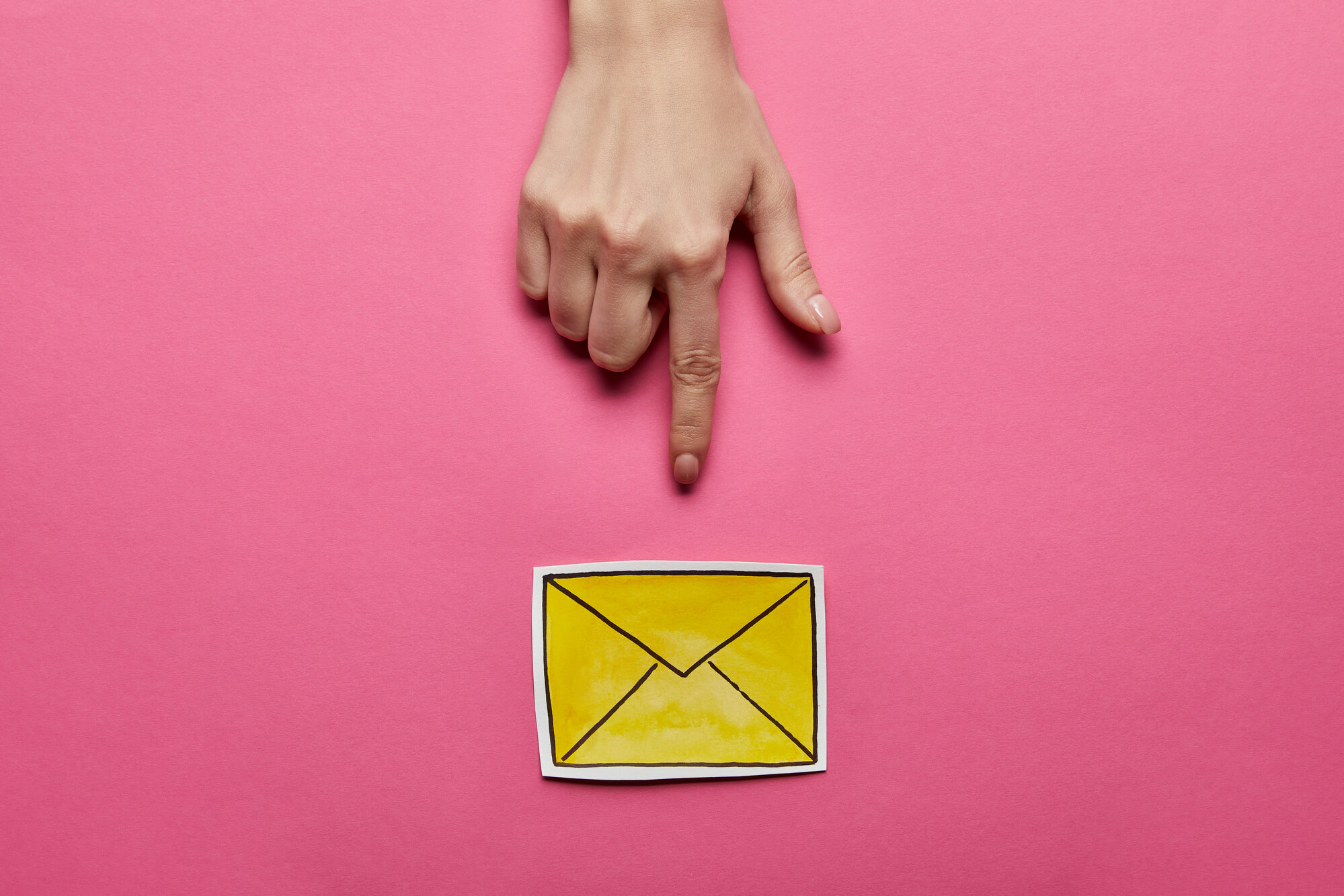 hand pointing at yellow mail icon