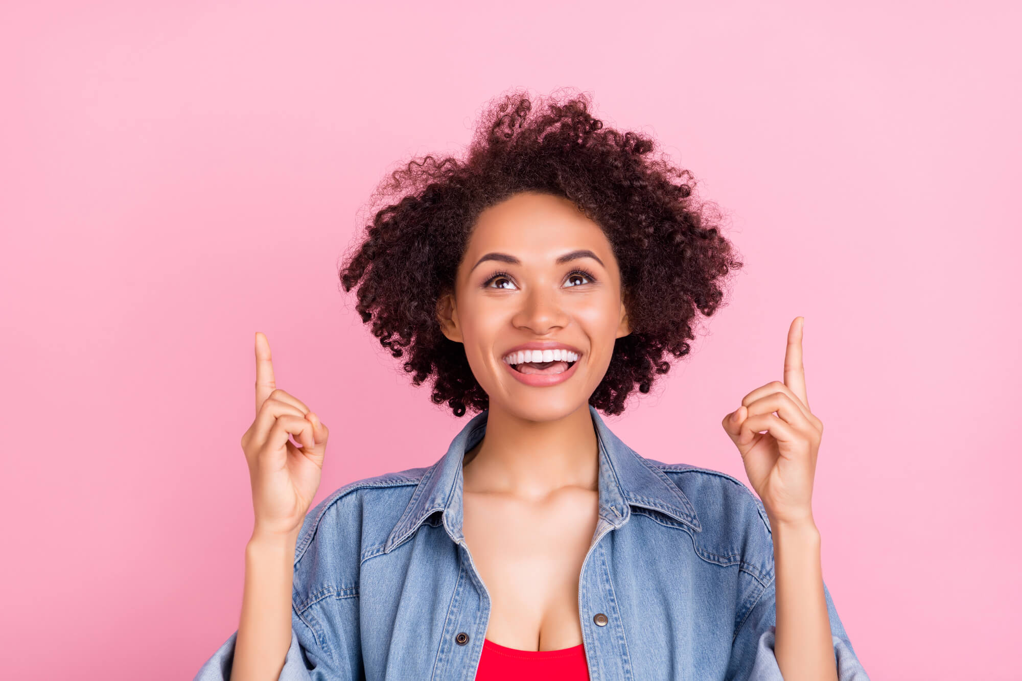 elated digital marketer pointing fingers upwards  