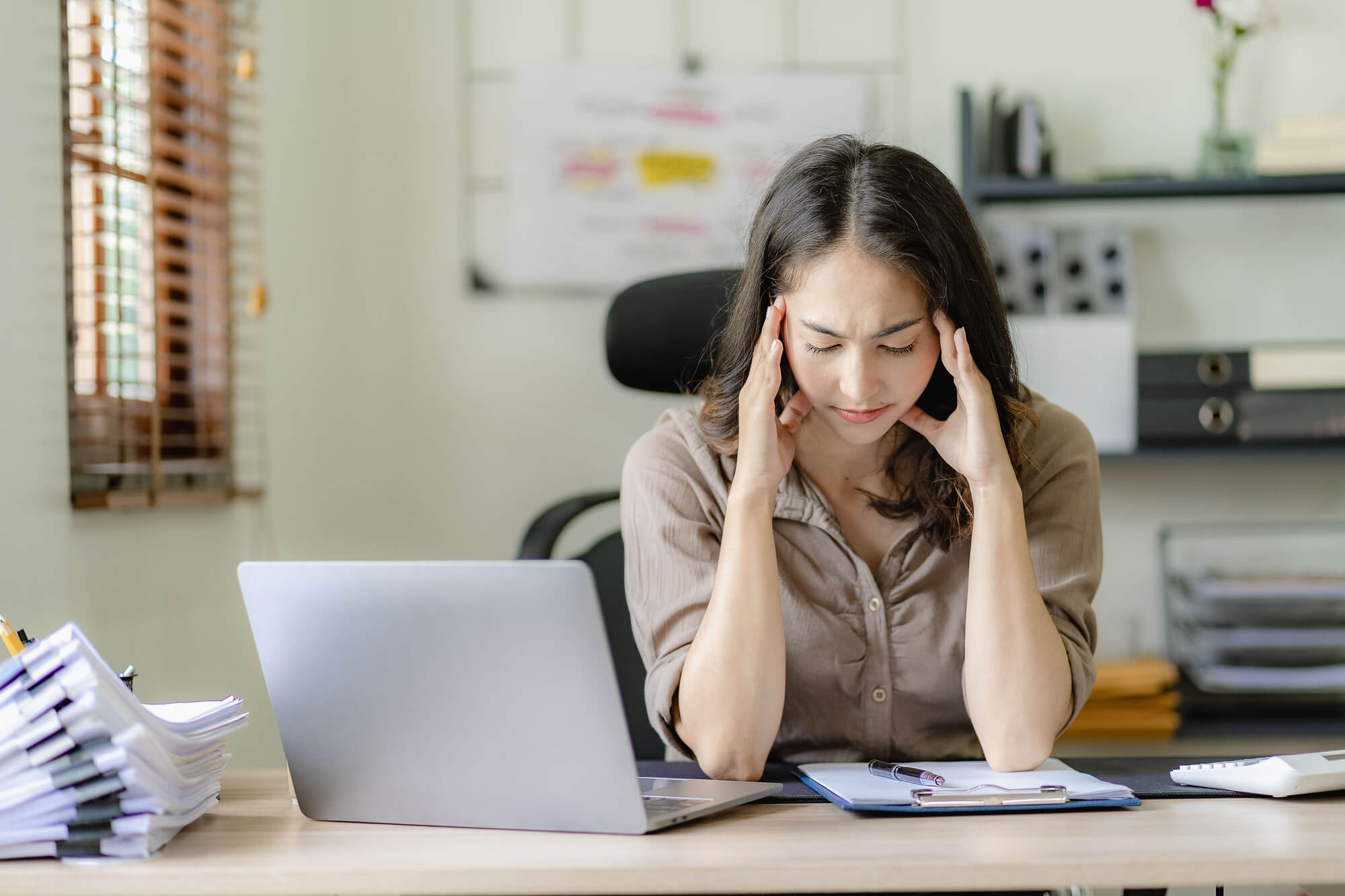 businesswoman has a headache in the office