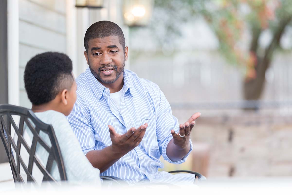 Dad and son talking