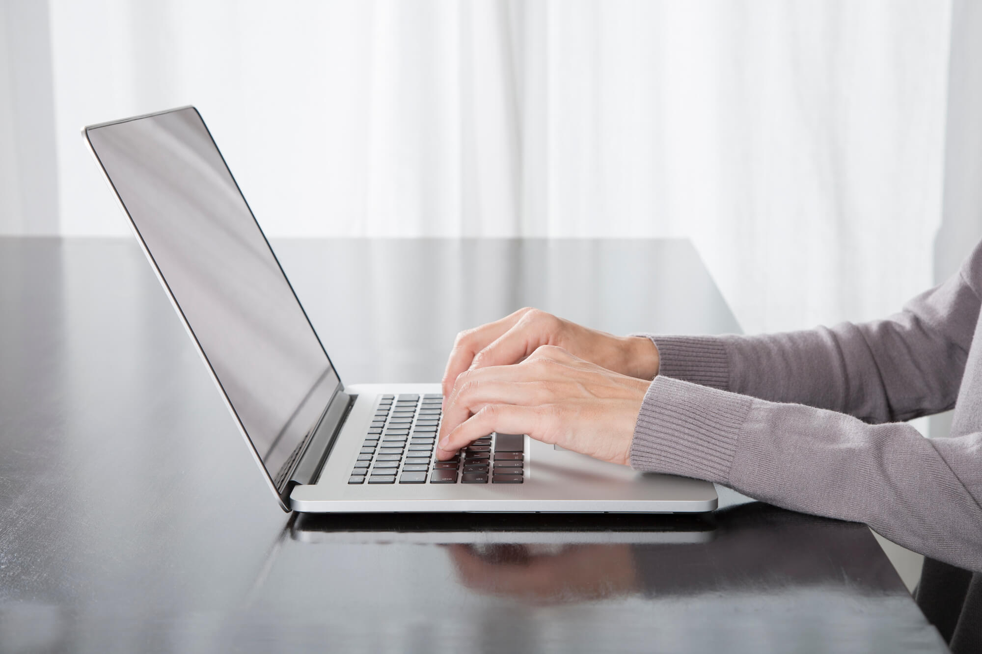 person typing on laptop