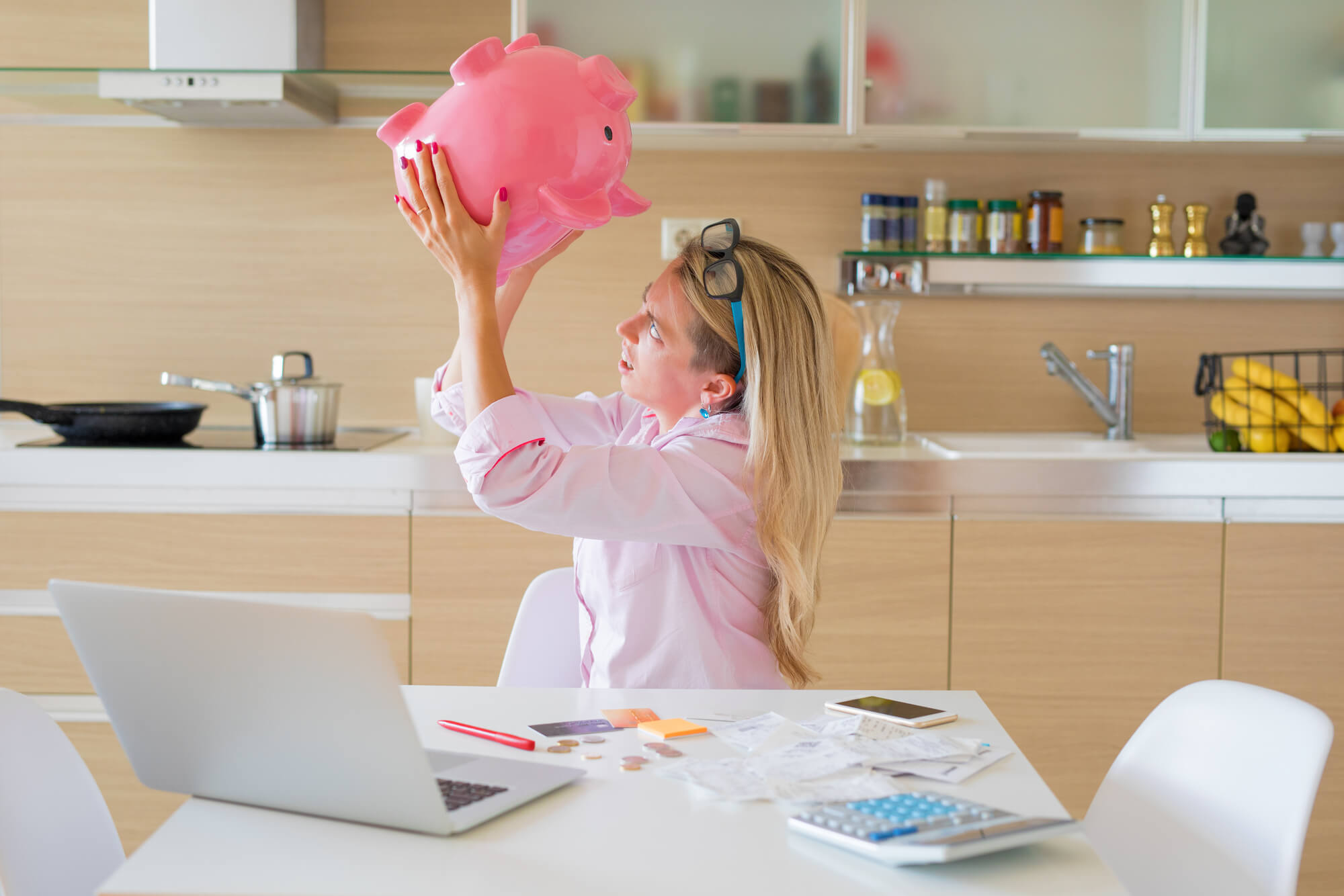 woman checking what's left in her piggy bank