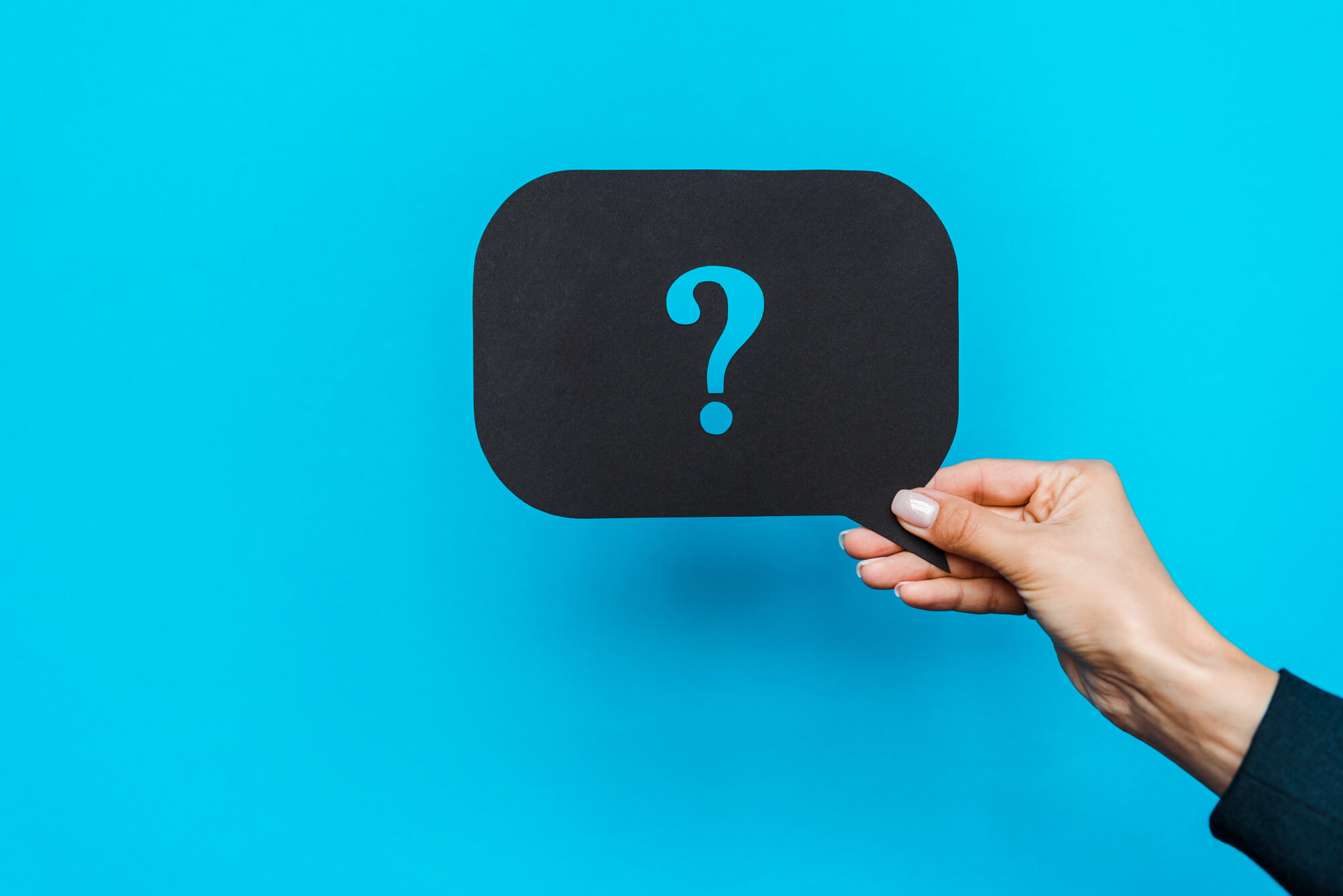 hand holding speech bubble with question mark