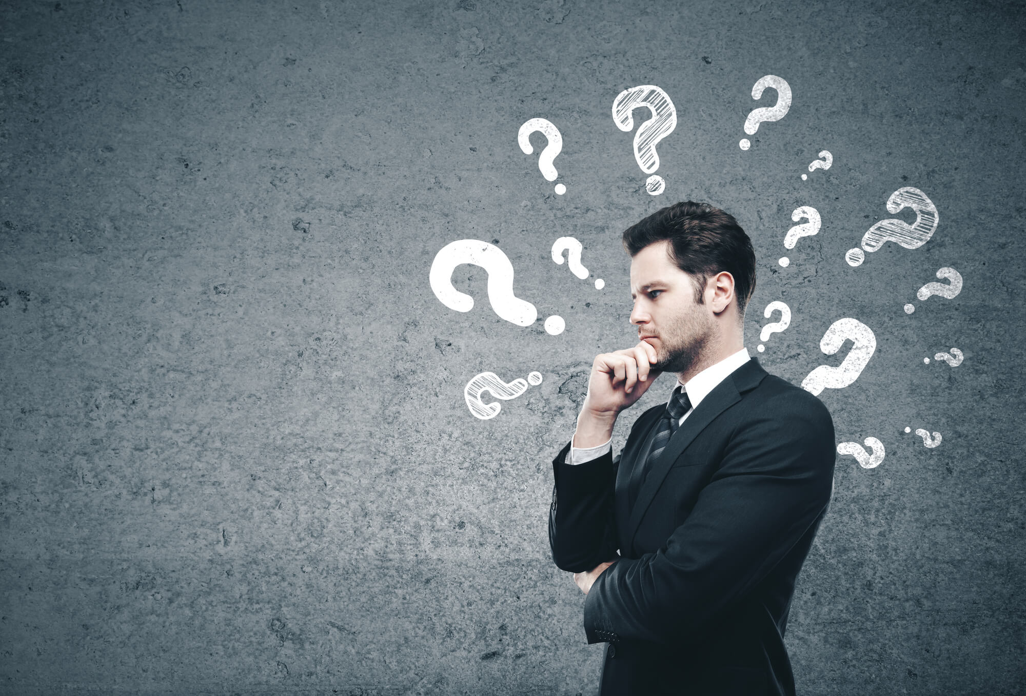 businessman thinking with question marks on background
