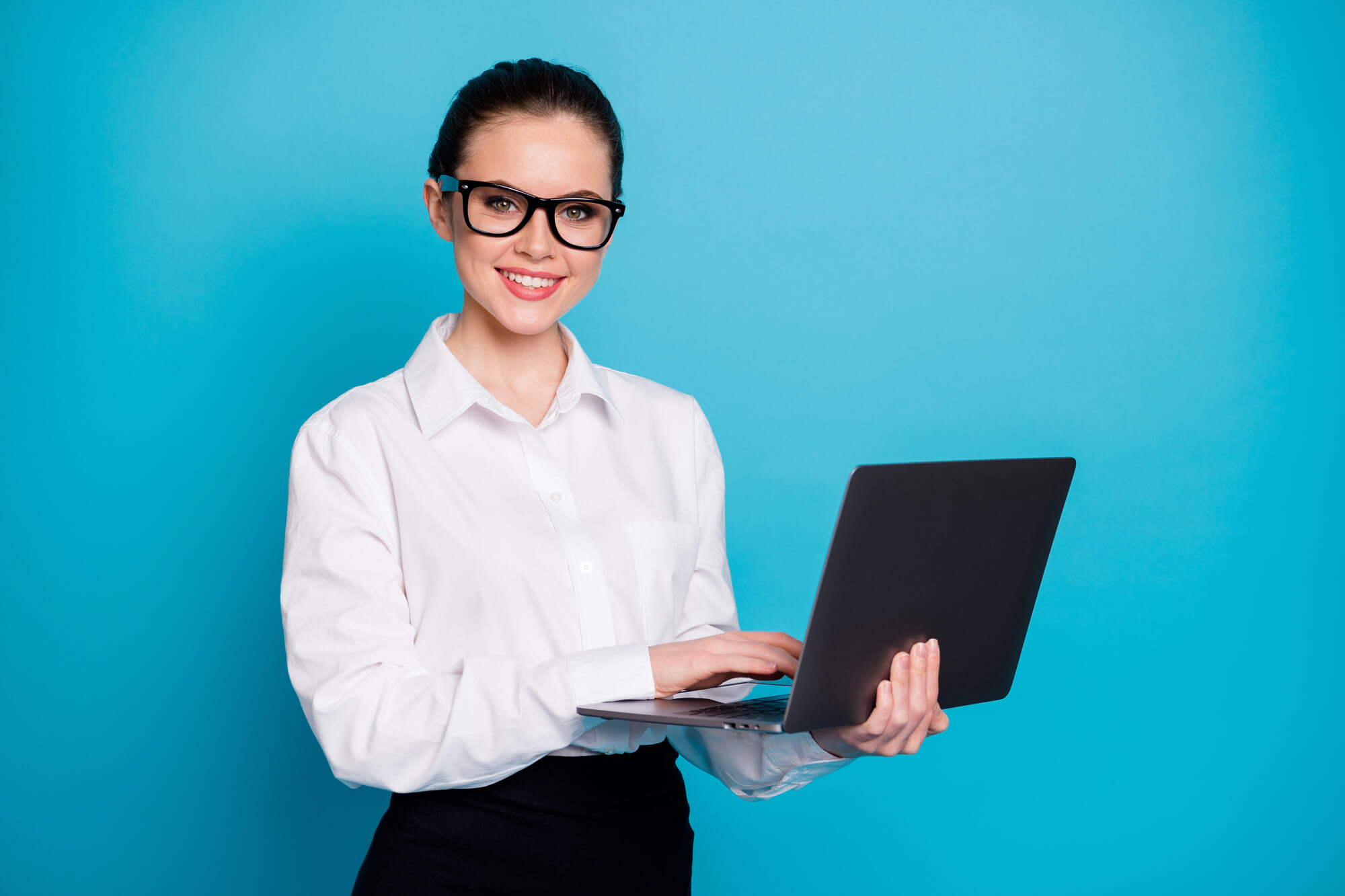 smiling digital marketer holding a laptop