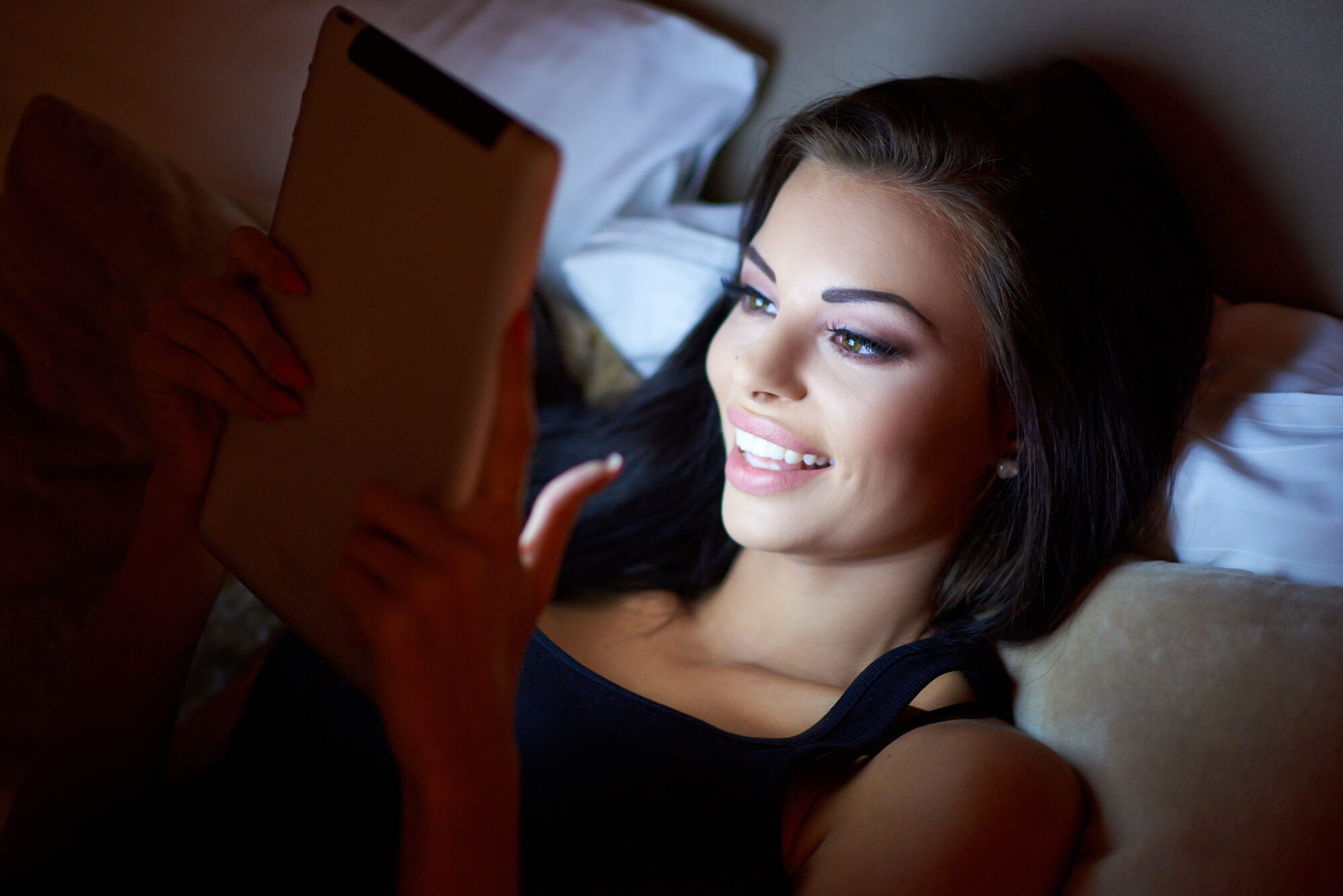woman smiling while reading