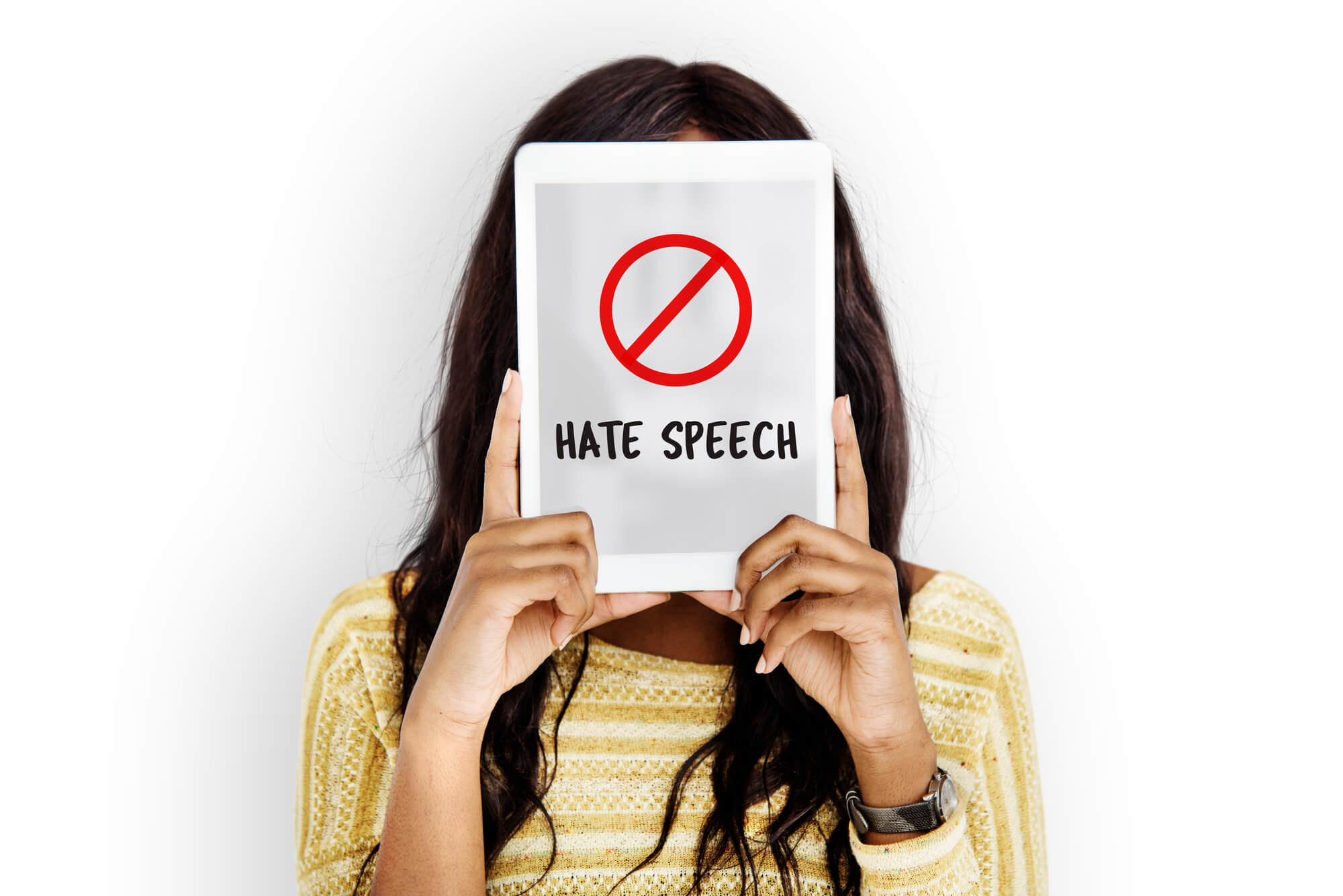 woman holding tablet with anti-hate speech on screen