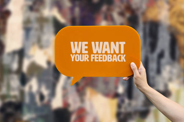 hand holding speech bubble that says we want your feedback