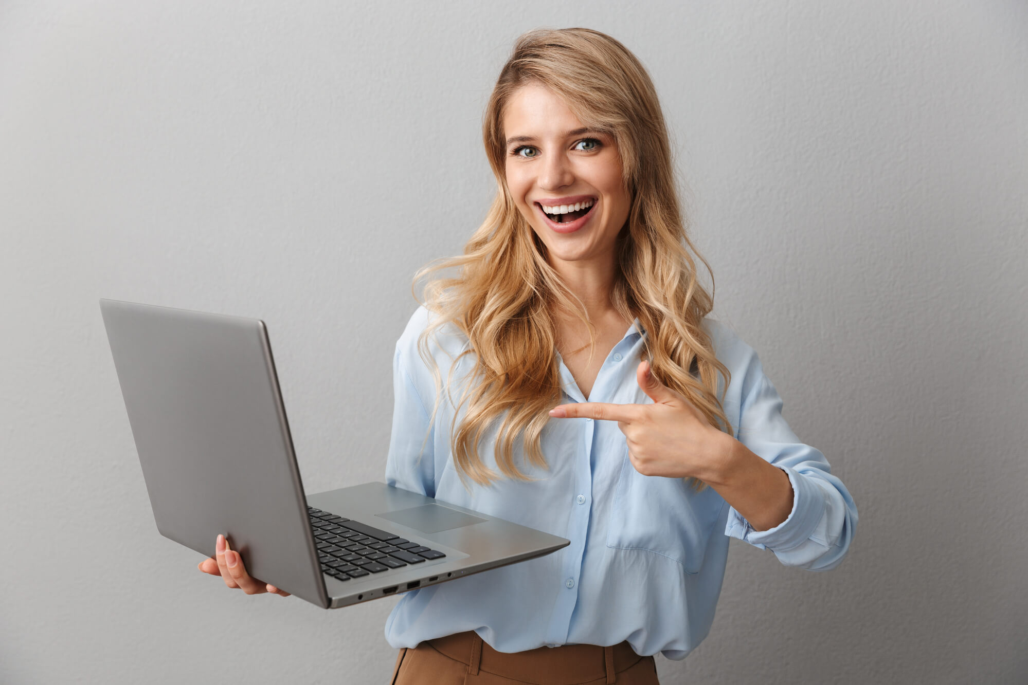 inviting female digital marketer pointing to her laptop