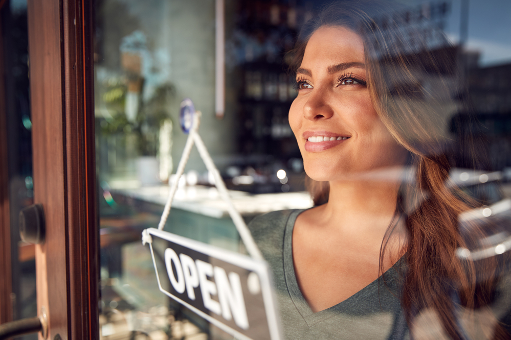 Small business owner smiling at customers.