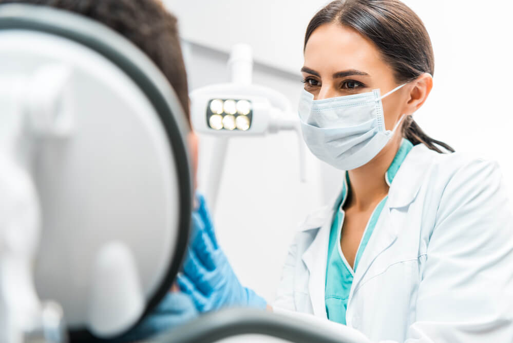 Dentist collaborating with influencer to boost trust and drive more patients to dental clinic.
