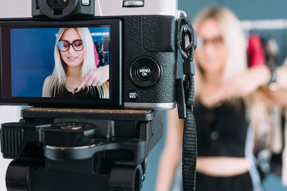 Fashion stylist shooting a behind-the-scenes style vlog.