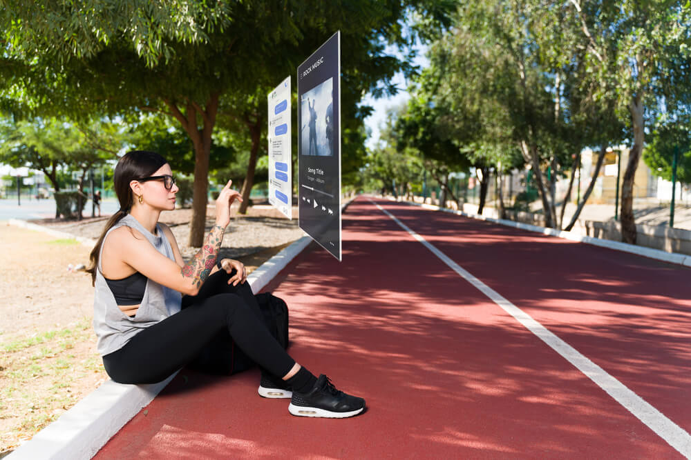 woman resting after a workout and texting through augmented reality.