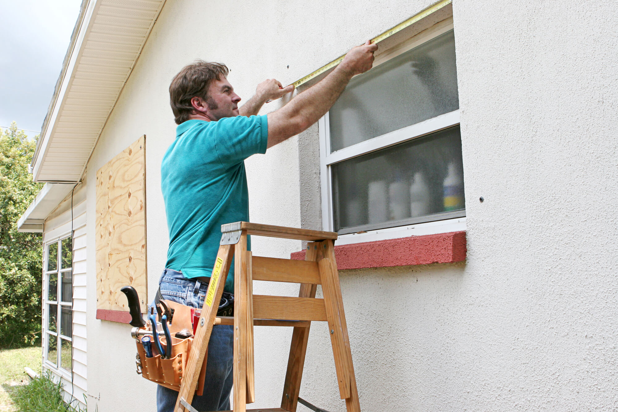 a male carpenter fixing the window