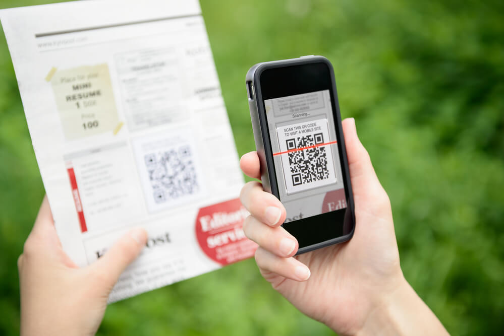 Customer scanning QR code to leave a review after receiving package. 