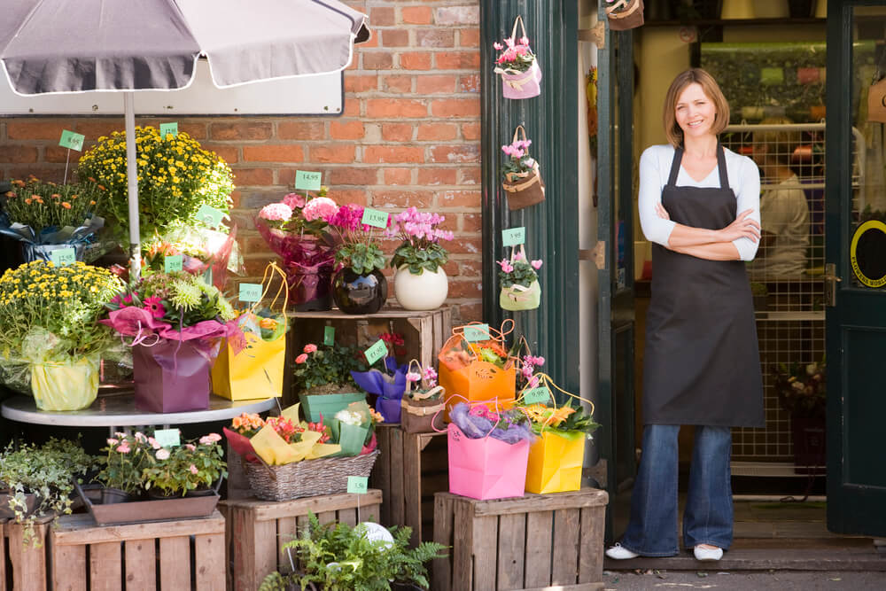 small business owner smiling while working in her flower shop