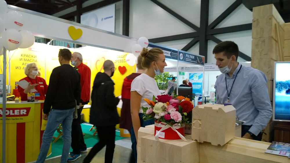Business man talking to a potential customer in a trade show.