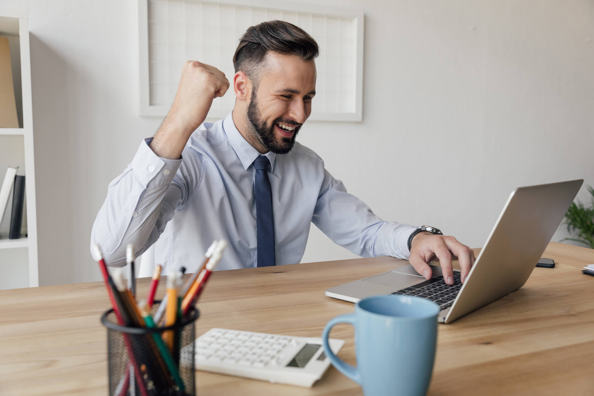 businessman looking happily at laptop