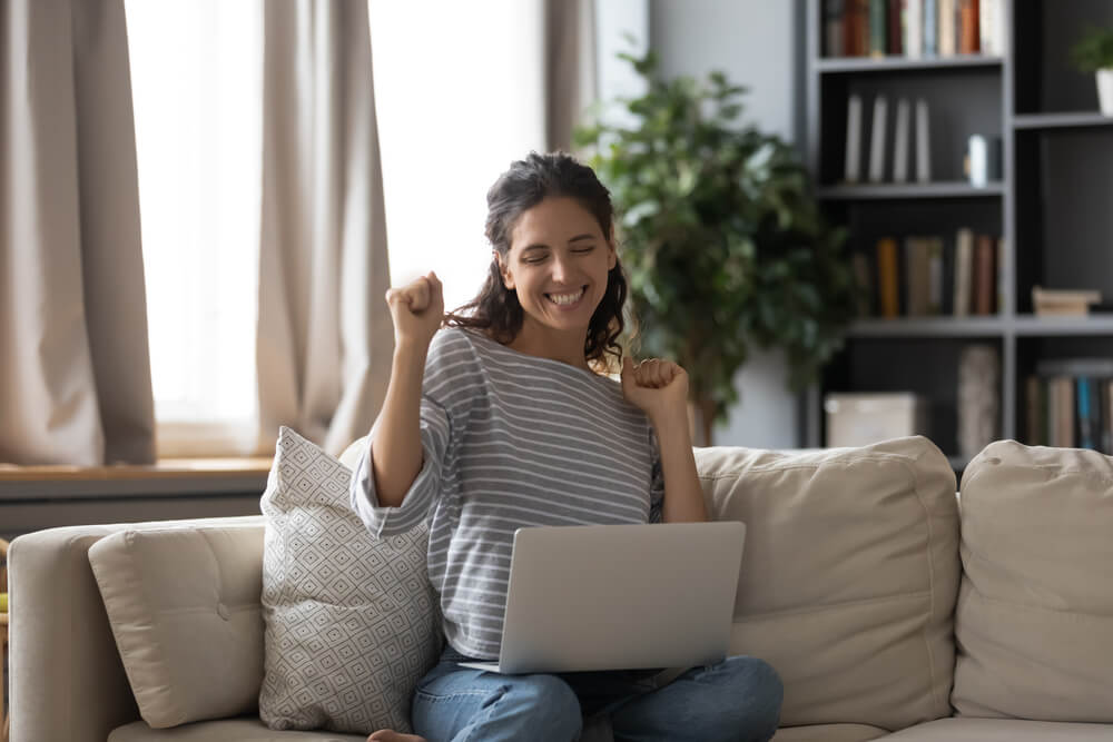 happy female customer looking at computer screen and reading relevant email from Miami SEO services