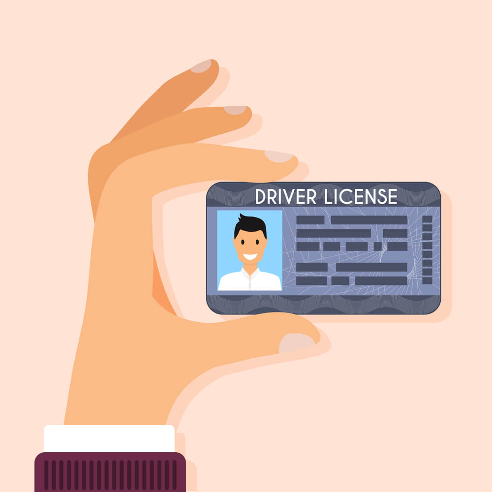 customer's hand holding a driver's license