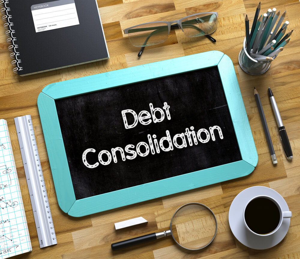 debt consolidation written on a small chalk board on top of an Internet Marketing Miami company's desk