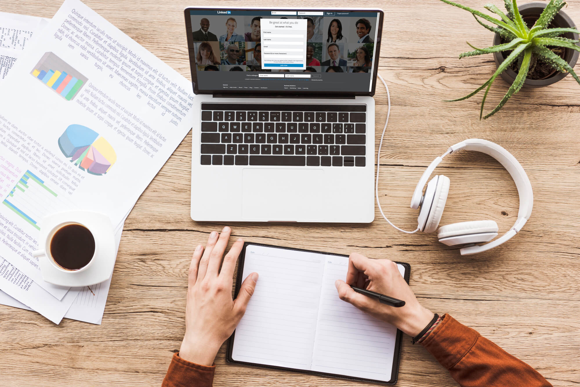 man taking notes while trying to sign up to a web hosting service
