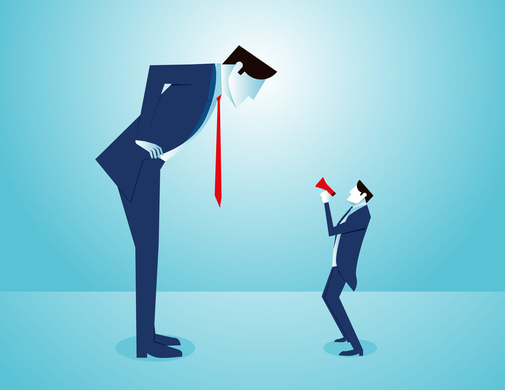 business man looking down at an employee