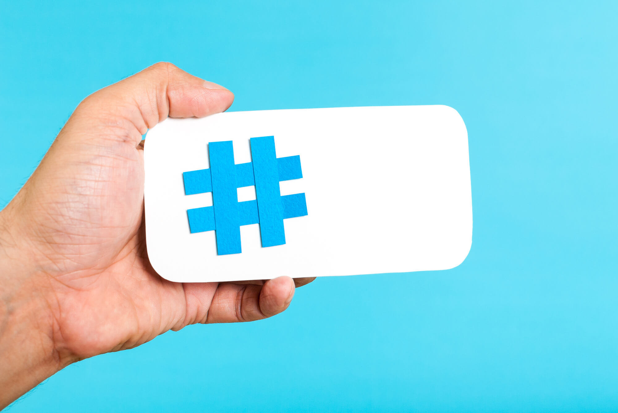hand holding paper with hashtag sign