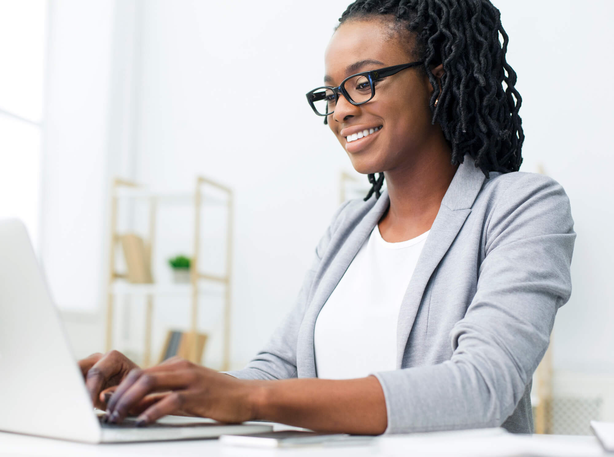female professional happily working on her laptop
