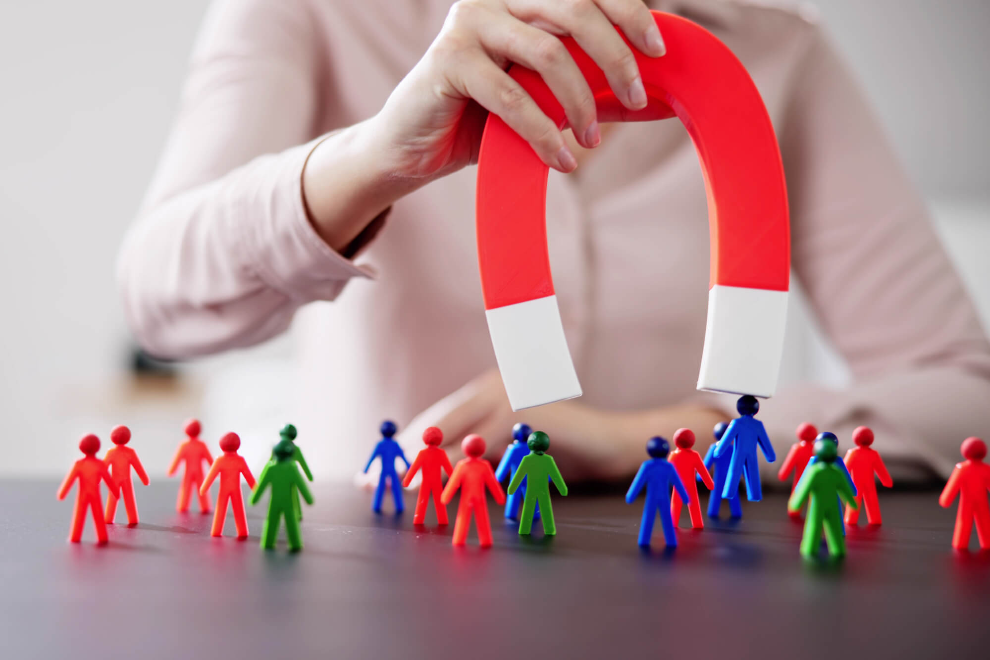 female professional holding magnet to attract customers