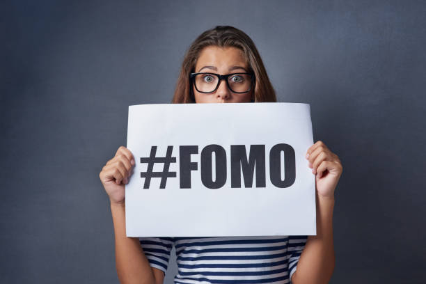 woman holding #fomo sign