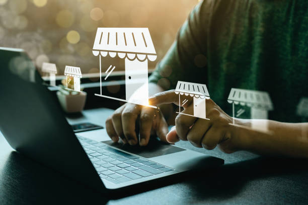 marketer working on laptop with franchise logos coming out