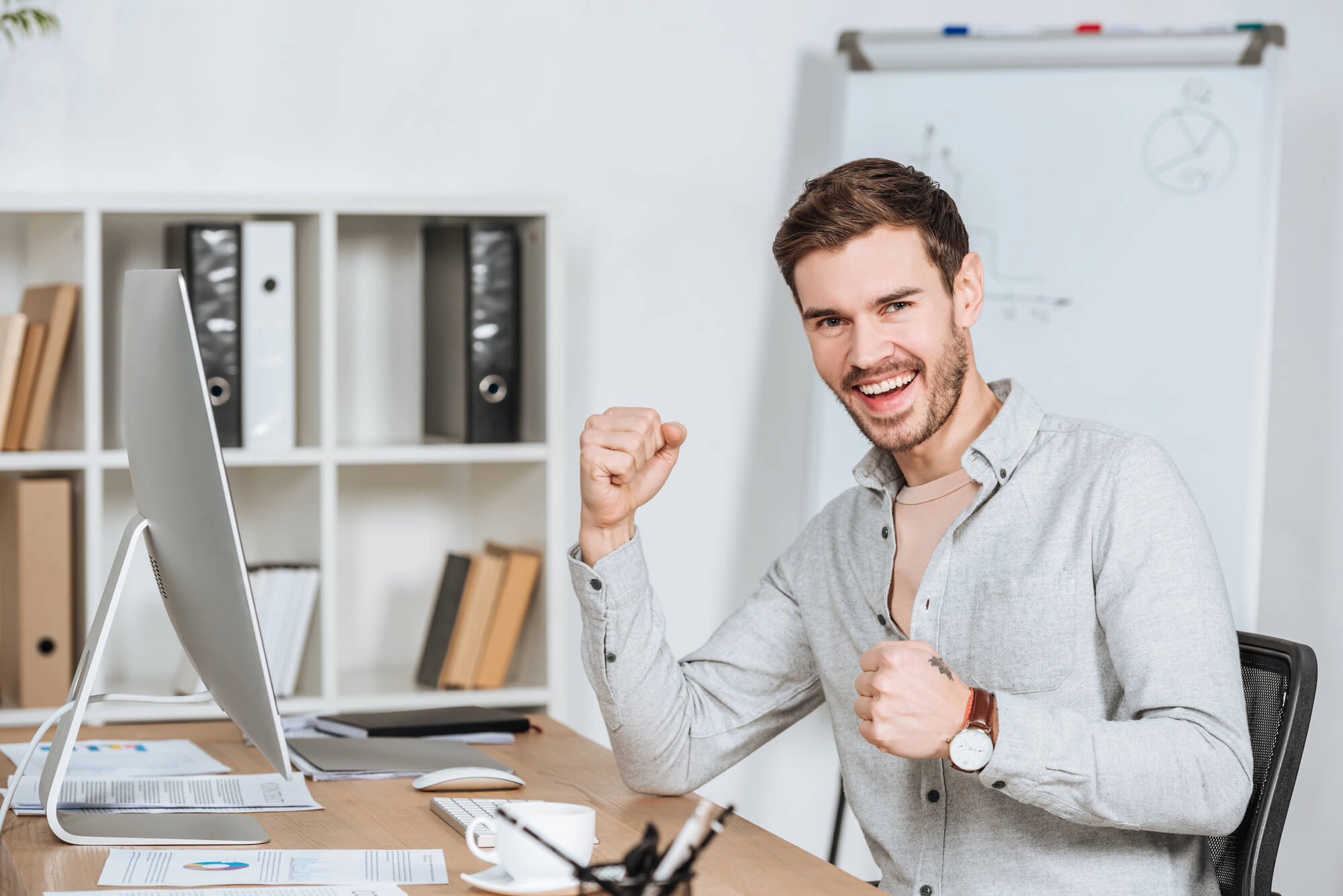 male marketer posing with a triumphant smile 