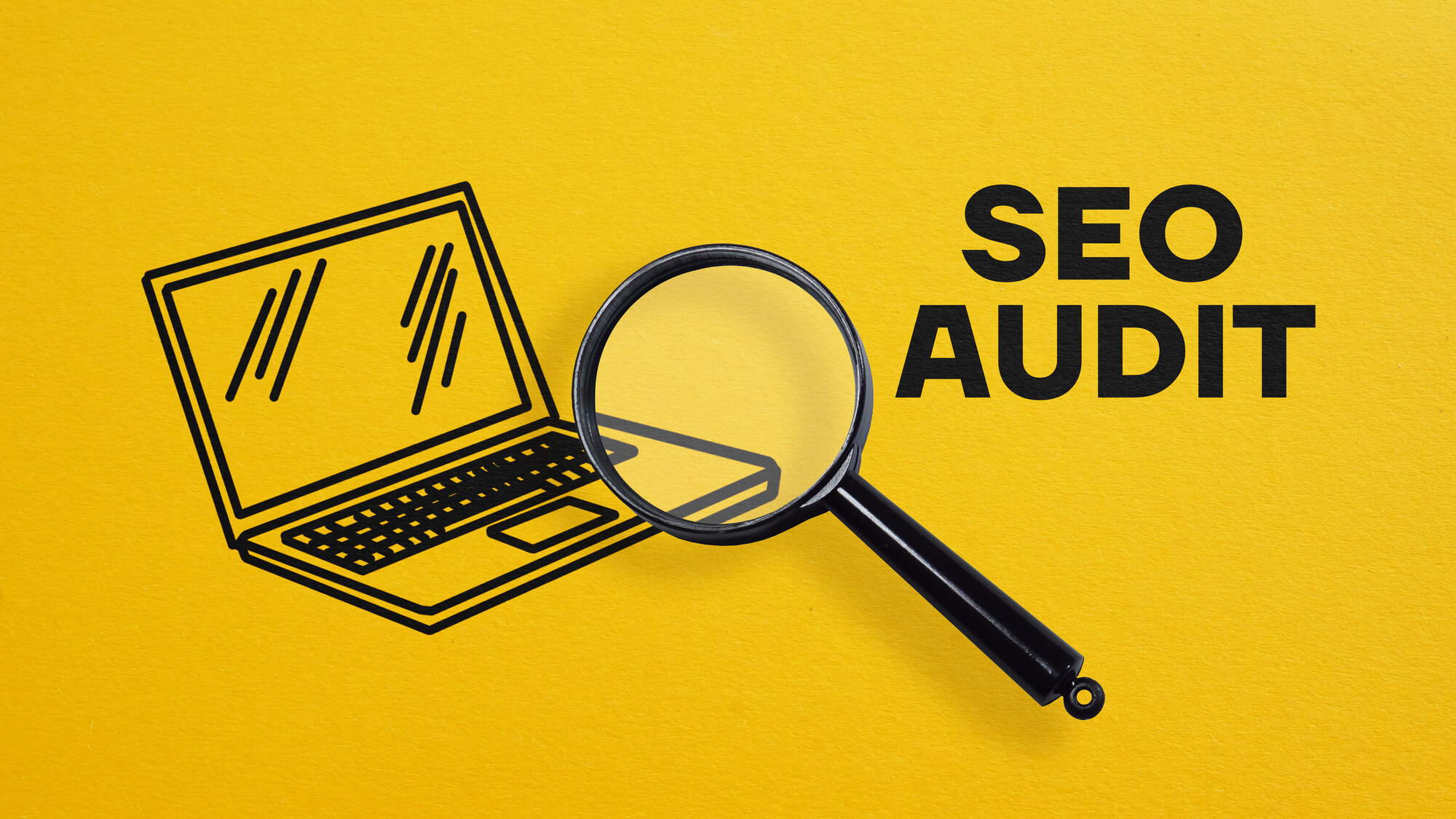 magnifying glass on top of a laptop sketch with the words seo audit beside it