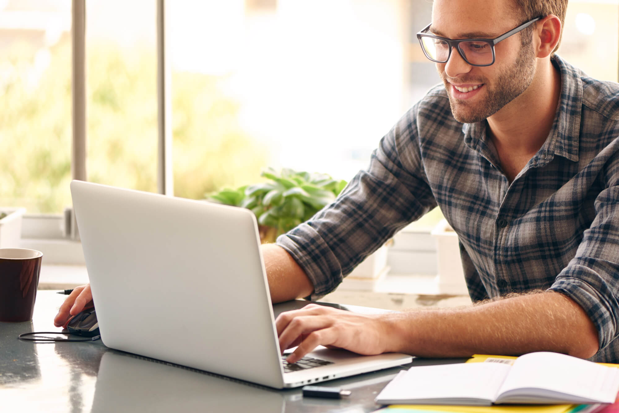 young entrepreneur looking happily at laptop
