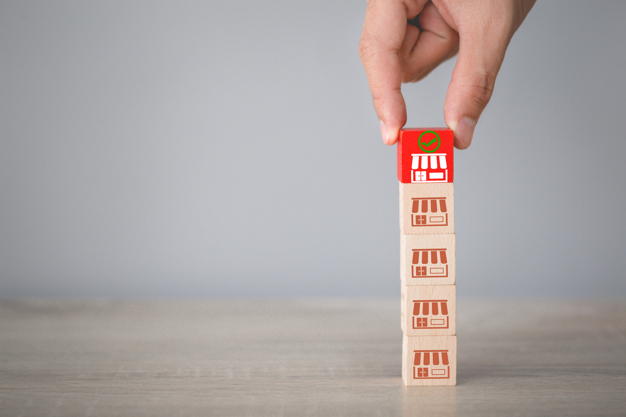 wooden blocks with store logos representing franchise