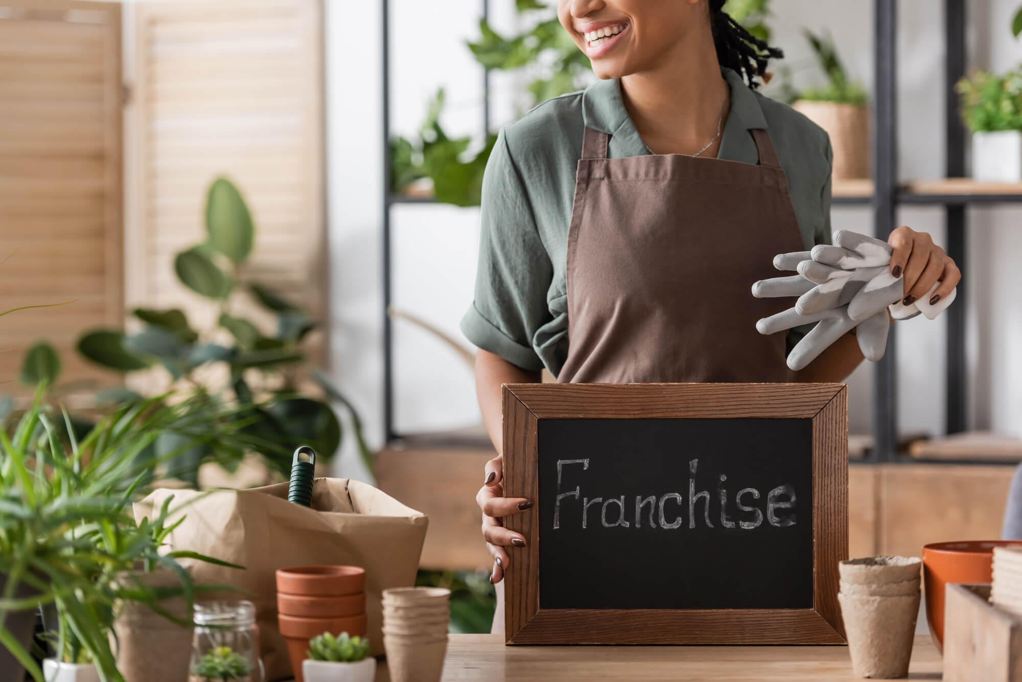 floral shop owner holding franchise sign