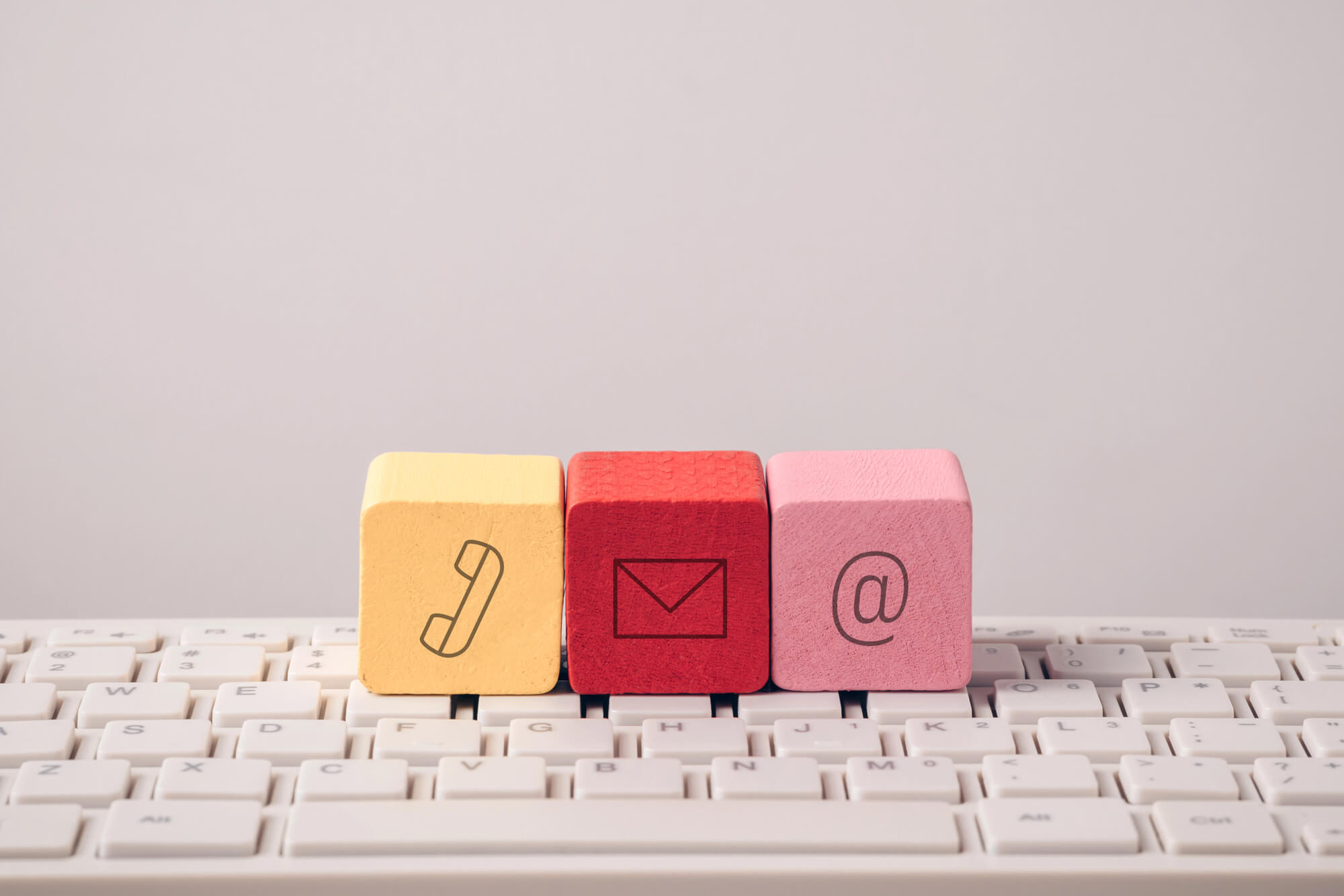 colorful blocks showing icons of phone, mail, and email 