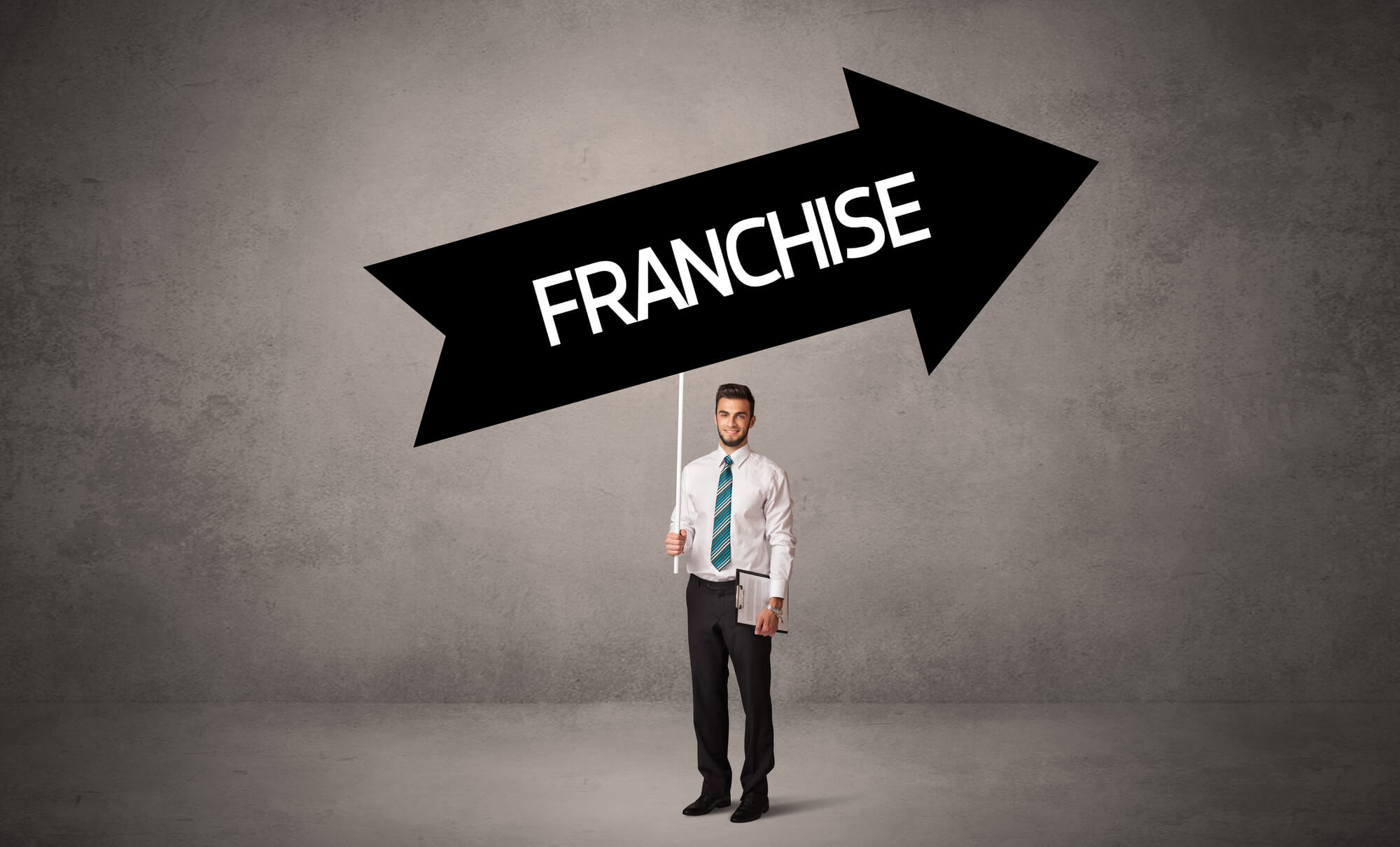 businessman holding franchise arrow sign leading up