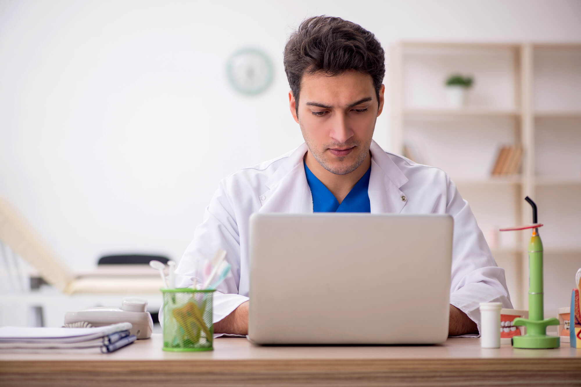 dentist working on laptop